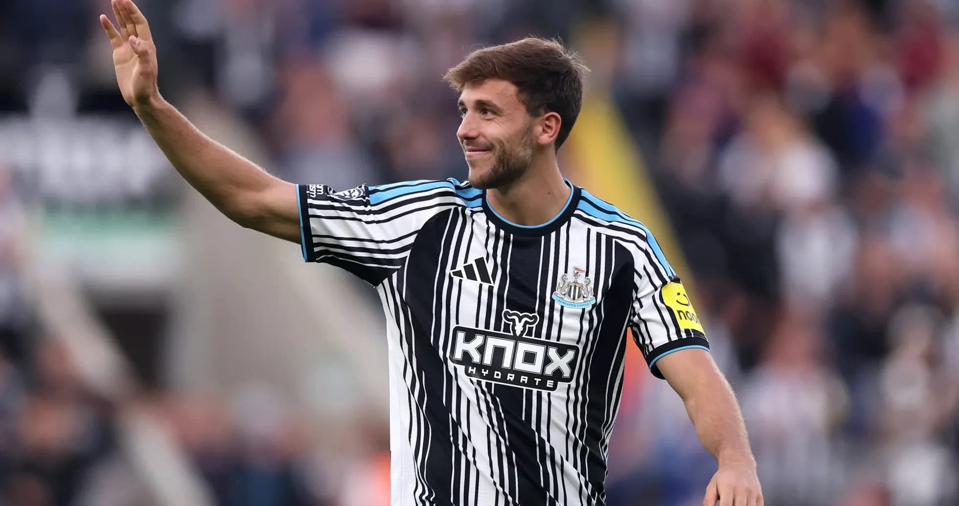 Игрок Newcastle United приветствует болельщиков на стадионе