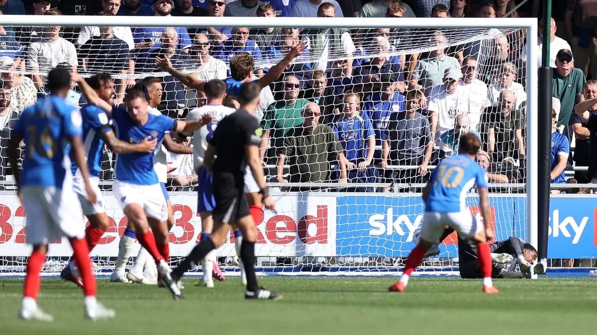 Players celebrating a goal in front of fans