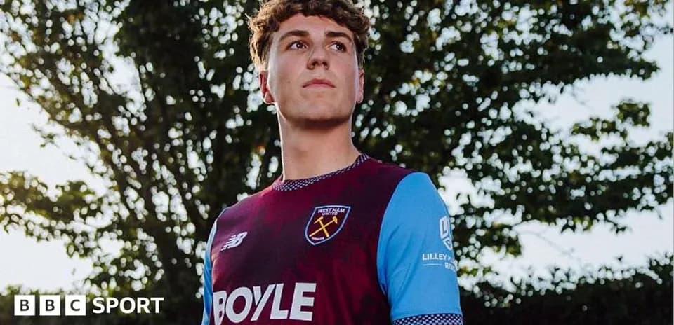 Игрок в форме West Ham United на фоне деревьев