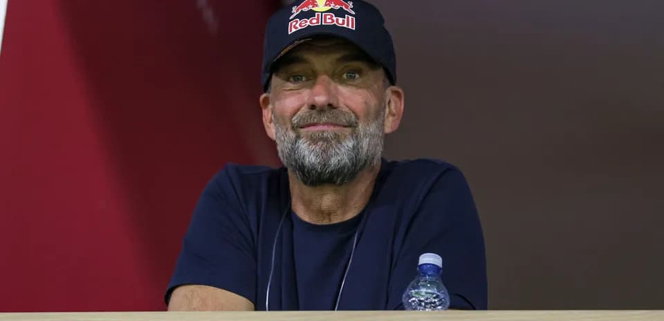 Человек в кепке Red Bull наблюдает за игрой