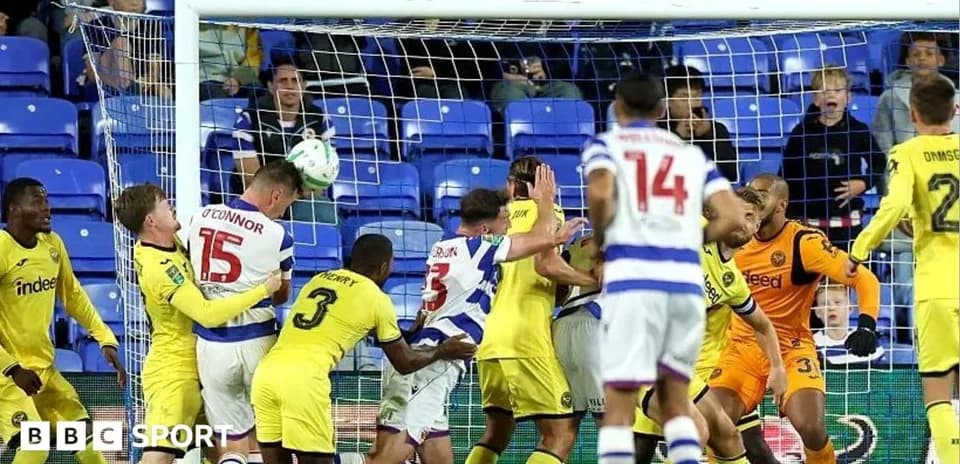 Players battling for the ball near the goal