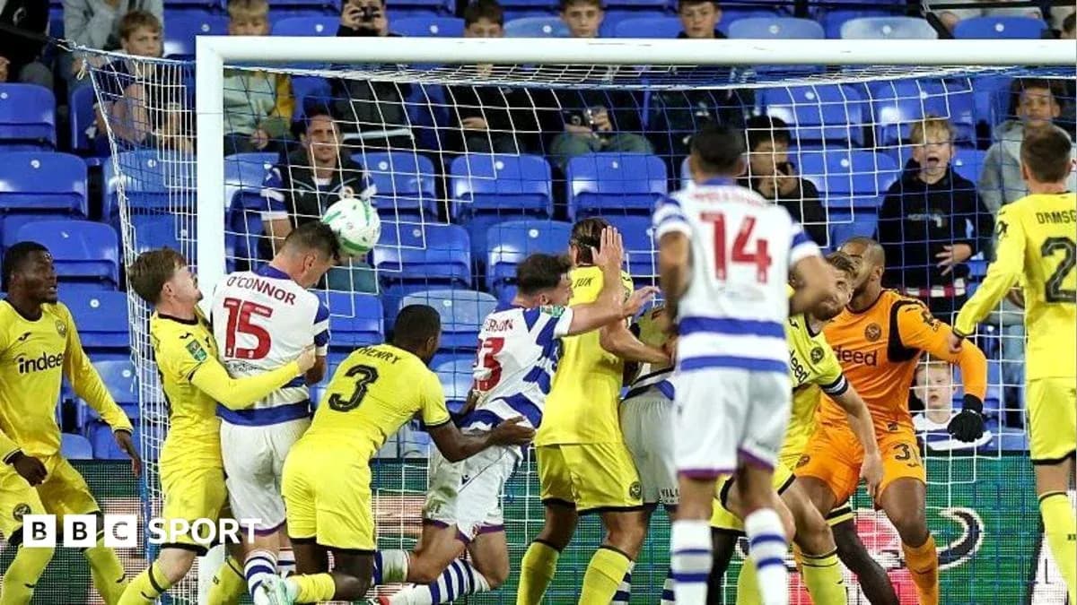 Players battling for the ball near the goal