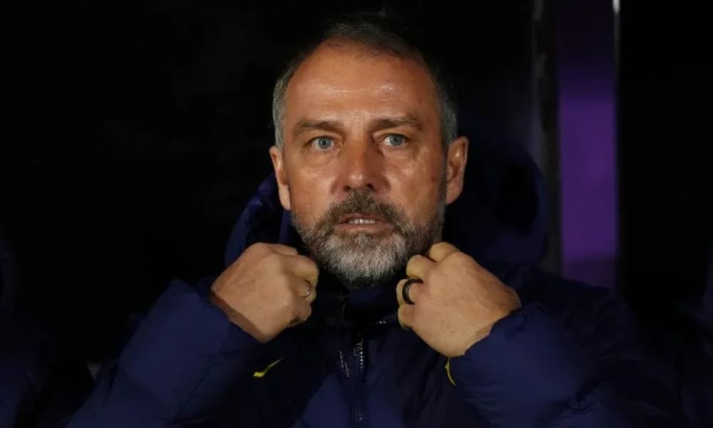 Тренер adjusting his jacket on the sidelines